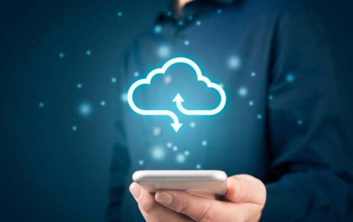 A man holds a phone with a sparkly graphic of a cloud emanating from it.