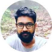 Headshot of a bearded man in a grey shirt.